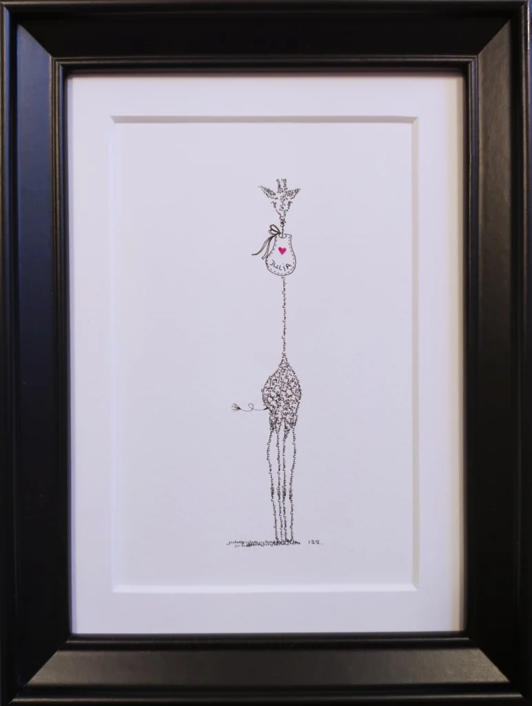Framed baby giraffe calligram with a bib